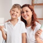 Happy,Mother,And,Her,Little,Son,With,Electric,Toothbrushes,In